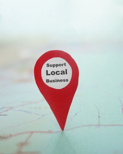 Map with a prominently placed red pin, emphasizing the importance of supporting local businesses.